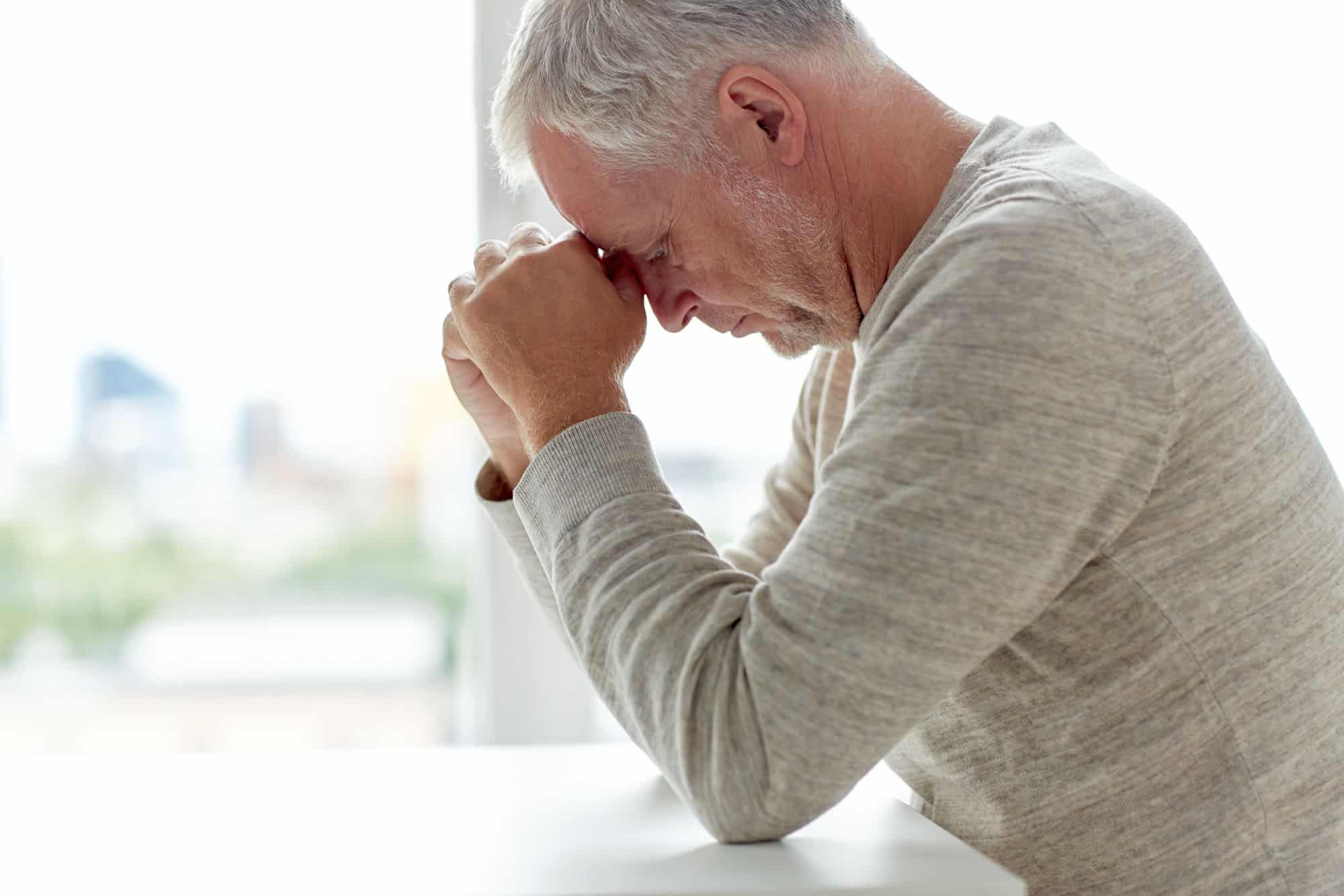 old age, problem and people concept close up of senior man thinking